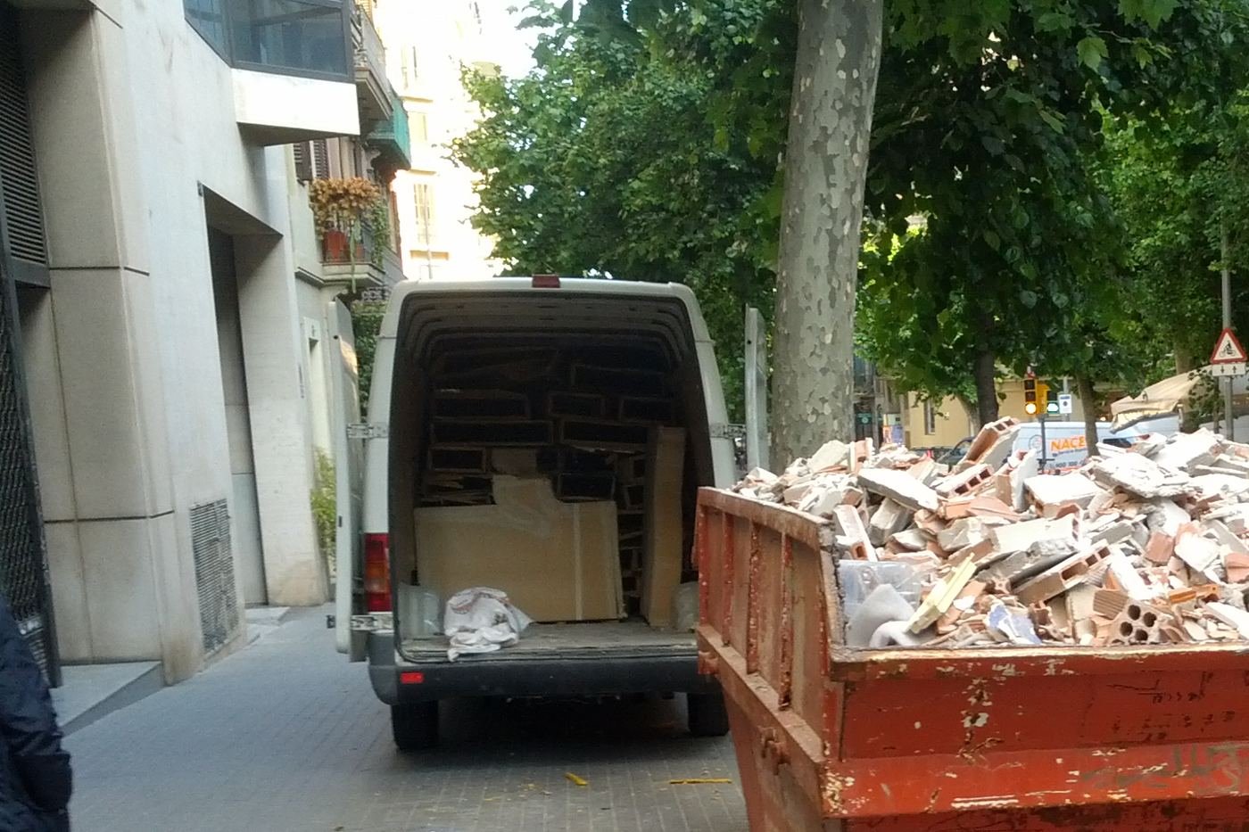 Roll-off dumpster and delivery van on a job site